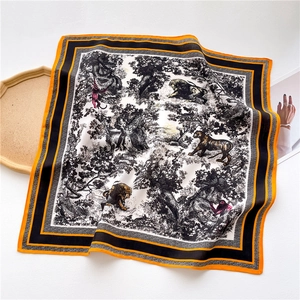 Detail of square silk scarf with jungle animal print and contrast orange borders