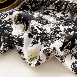 Close-up of Toile de Jouy silk scarf showing leopard animal prints and twill texture