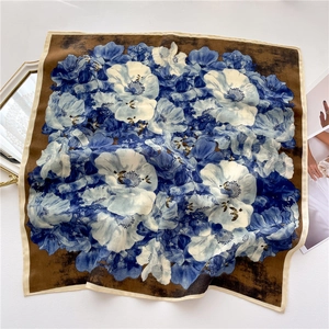 Detail of square silk scarf with vintage floral patterns and smooth texture folds