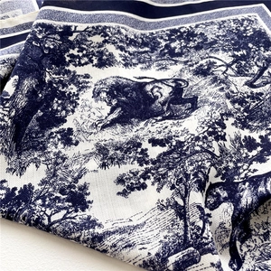 Close-up of blue and white Toile de Jouy pattern on twill silk scarf fabric