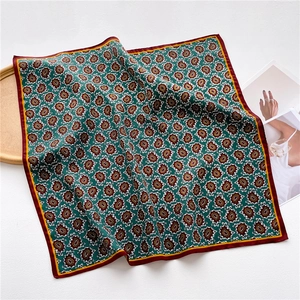 Detail of dark green paisley square scarf with vintage burgundy and gold borders