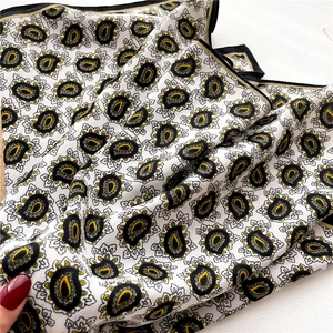 Elegant yellow and black paisley silk scarf with pearl luster and delicate texture