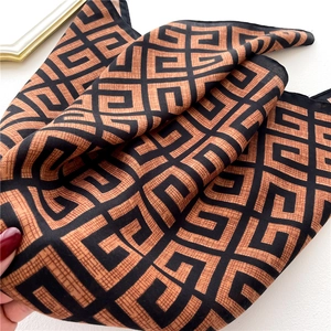Close-up of geometric pattern scarf with natural fabric folds and soft texture drape