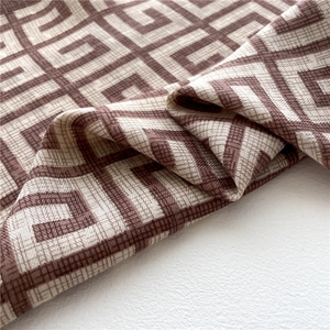 Close-up of geometric square pattern textile with brown and beige woven texture