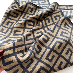 Classic khaki and black geometric maze pattern scarf with delicate edge stitching