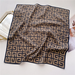Detail of vintage geometric silk scarf with luxury pattern and smooth satin texture