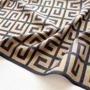 Detail shot of khaki geometric square scarf with textured herringbone silk-like fabric