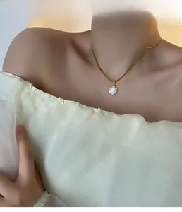 Exquisite gold snake chain necklace with white turtle shell pendant on female model