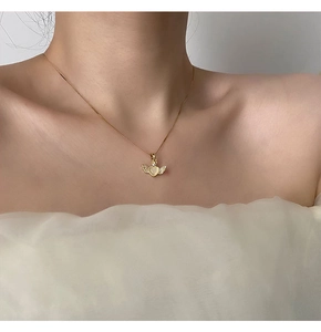 Detail of angel heart necklace with cat eye stone and golden wings on a female model