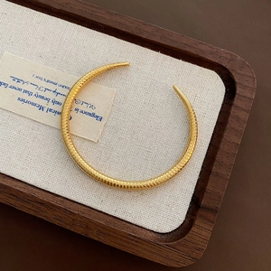 Polished gold adjustable snake-textured cuff bangle made of premium titanium steel