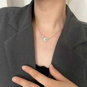 Minimalist silver steel heart necklace with pearl and BEAUTY engraving on neck