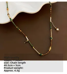 Detailed shot of ethnic beaded necklace featuring pearls and turquoise on a white plate