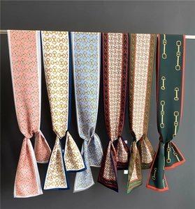 Detail showing six colors of double-sided print satin twilly scarves with chain pattern