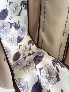 Detail of floral printed double-sided silk ribbon scarf with 'I love summer' text