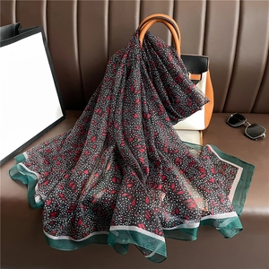 Floral faux silk shawl with white polka dots and red leaf patterns on a luxury handbag