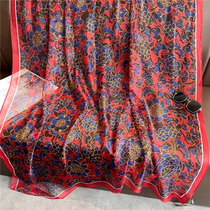 Luxurious large floral silk-like scarf in vibrant red with retro patterns and sunglasses