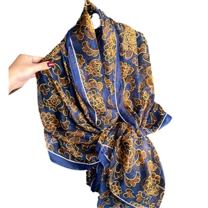 Luxurious sun protection silk shawl with golden floral patterns on a deep blue base