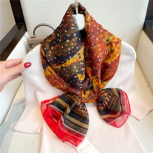 Detailed shot of lightweight polka dot silk shawl with vintage ethnic floral patterns