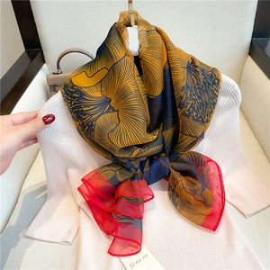 Detailed view of lightweight floral silk scarf with vibrant prints and translucent texture
