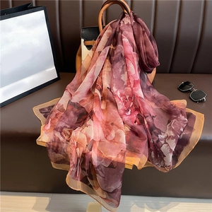 Luxurious faux silk shawl with floral watercolor print draped on a designer handbag