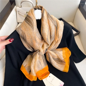 Champagne and orange silk scarf with abstract ripple pattern and hand-rolled edges