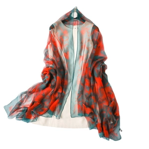 Lightweight silk shawl with vibrant red floral pattern on dark green background