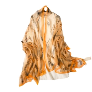 Elegant orange silk-like shawl with wavy black patterns for sun protection