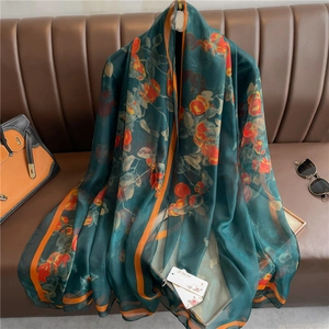 Elegant emerald green silk scarf with orange floral pattern and striped borders
