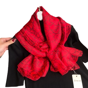 Luxurious red silk shawl featuring elegant black camellia patterns for a stylish look