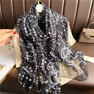 Elegant polka dot silk-like shawl scarf with white floral patterns on a black base