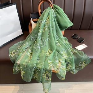 Floral green silk-like scarf draped on handbag, elegant large sunscreen shawl for women