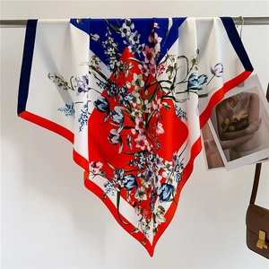 Detailed drape of floral silk scarf featuring elegant red and blue tulip patterns
