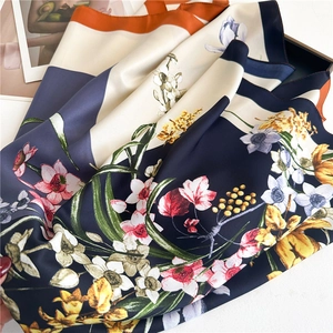 Floral print 90cm silk scarf with vibrant orange and navy blue floral patterns