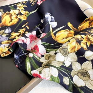Close-up of floral print silk scarf showing twill texture and tulip patterns