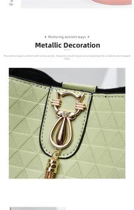 Close-up of light green handbag featuring triangle texture and gold cat tassel pendant