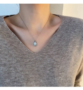 Détail du collier pendentif lapin porté au cou pour montrer la longueur et le style