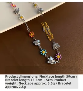 Detail of titanium steel daisy necklace and butterfly bracelet set with colorful enamel