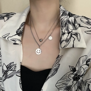 Double-layered silver smile pendant necklace with polished beads on a stylish chain