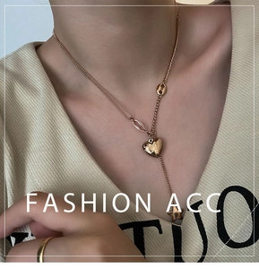 Close-up of double-layer rose gold titanium Y-necklace with heart and star charms