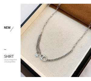 Detail of asymmetric titanium steel necklace with star charm and pig nose link design