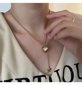 Detail of 18K gold-plated Y-necklace with heart 'Love' pendant and tiny star charm