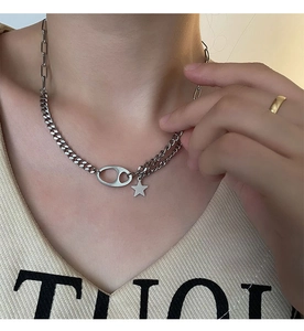 Close-up of titanium steel Cuban chain with star pendant and matte oval link detail
