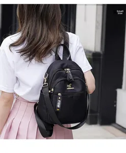 Small size black nylon backpack with metal kangaroo logo and multi-pocket detail