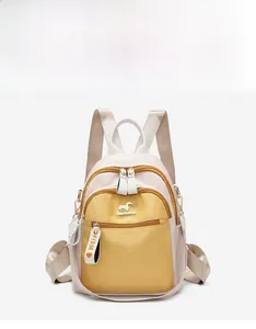 Detail view of the mini backpack showing color blocking and side pocket functionality