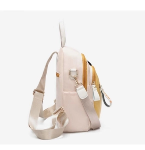 Detail view of mini backpack in pink and yellow with metal zipper and side pockets