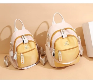 Detailed comparison of large and small color-block backpacks with FIDM ribbon detail