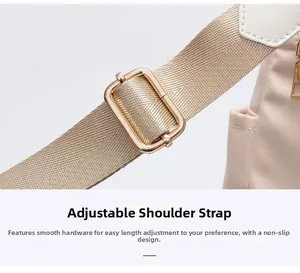 Detail of adjustable nylon shoulder strap with gold-tone hardware on beige backpack