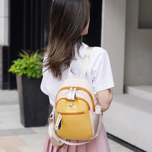 Women's color-block mini backpack in beige and yellow with metal kangaroo logo