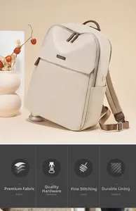 Detail view of cream nylon backpack featuring premium hardware and brown leather accents