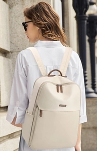 Chic cream-colored large capacity travel backpack shown on a model in an urban setting
